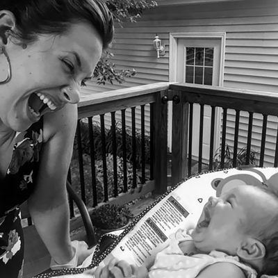 Person laughing with a baby.