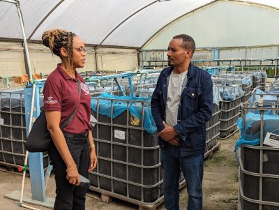 (From left) Carla Savage and Marshet Mitiku discussing aquaculture. 