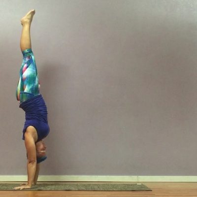 Person doing a yoga handstand.