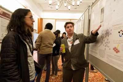 Participants conversing at the veterinary college’s annual research symposium. 