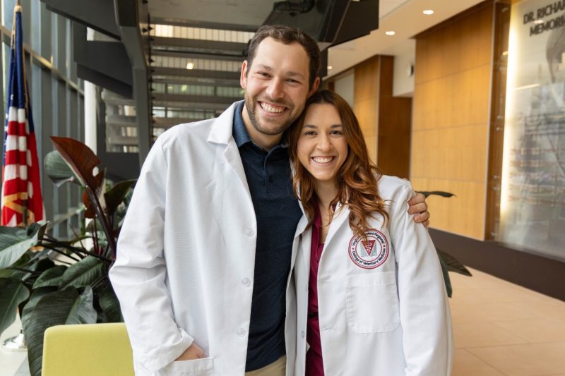 Mike Miglories and Nikki Migloires in their white coats.