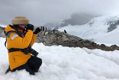 Lijuan Yuan taking a photo in the snow in Antarctica.