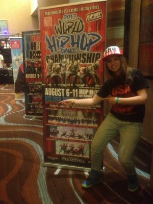 Skylar Moiseeva in front of a concert sign.