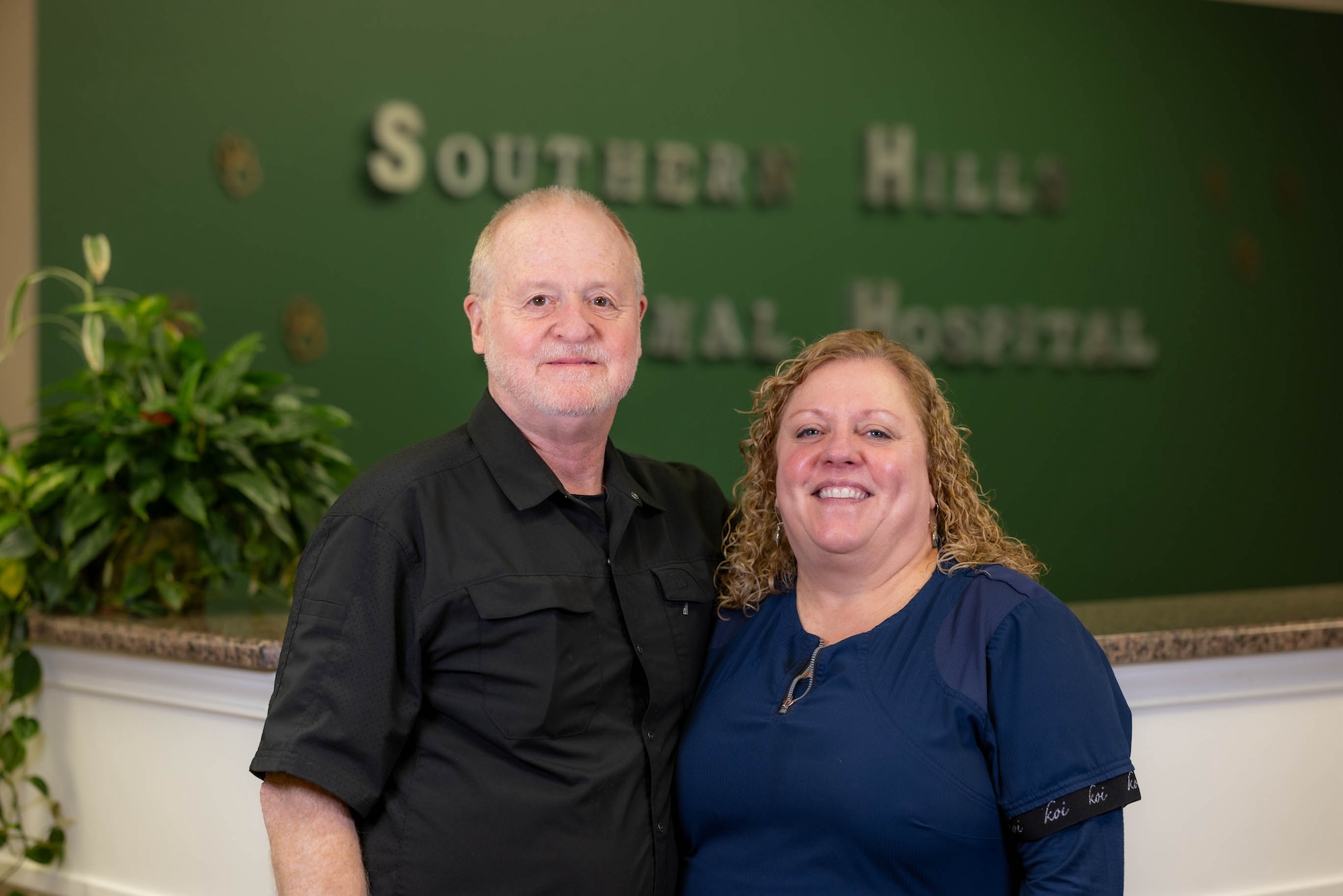 Dr. W Preston Thorton (at left) and Dr. Mary Thorton (at right) posing in the lobby of Southern Hills Animal Hospital