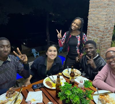 Louhan Dembele eating dinner with some friends from Micromek. Pictured: Mphatso Banda, Teresa Thorton, Katie Khethiwe Mtambo, and Tresfore Gawani.