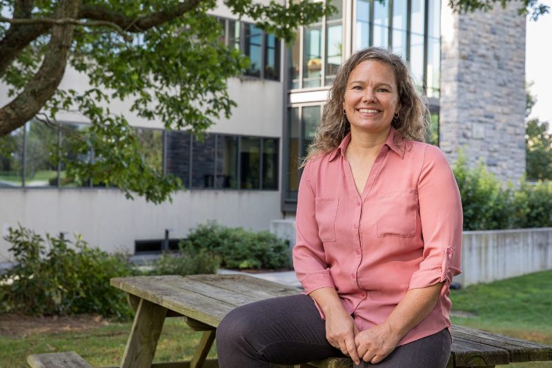 Photo of Associate Professor, Julia Gohlke in front of VA-MD College of Veterinary Medicine.