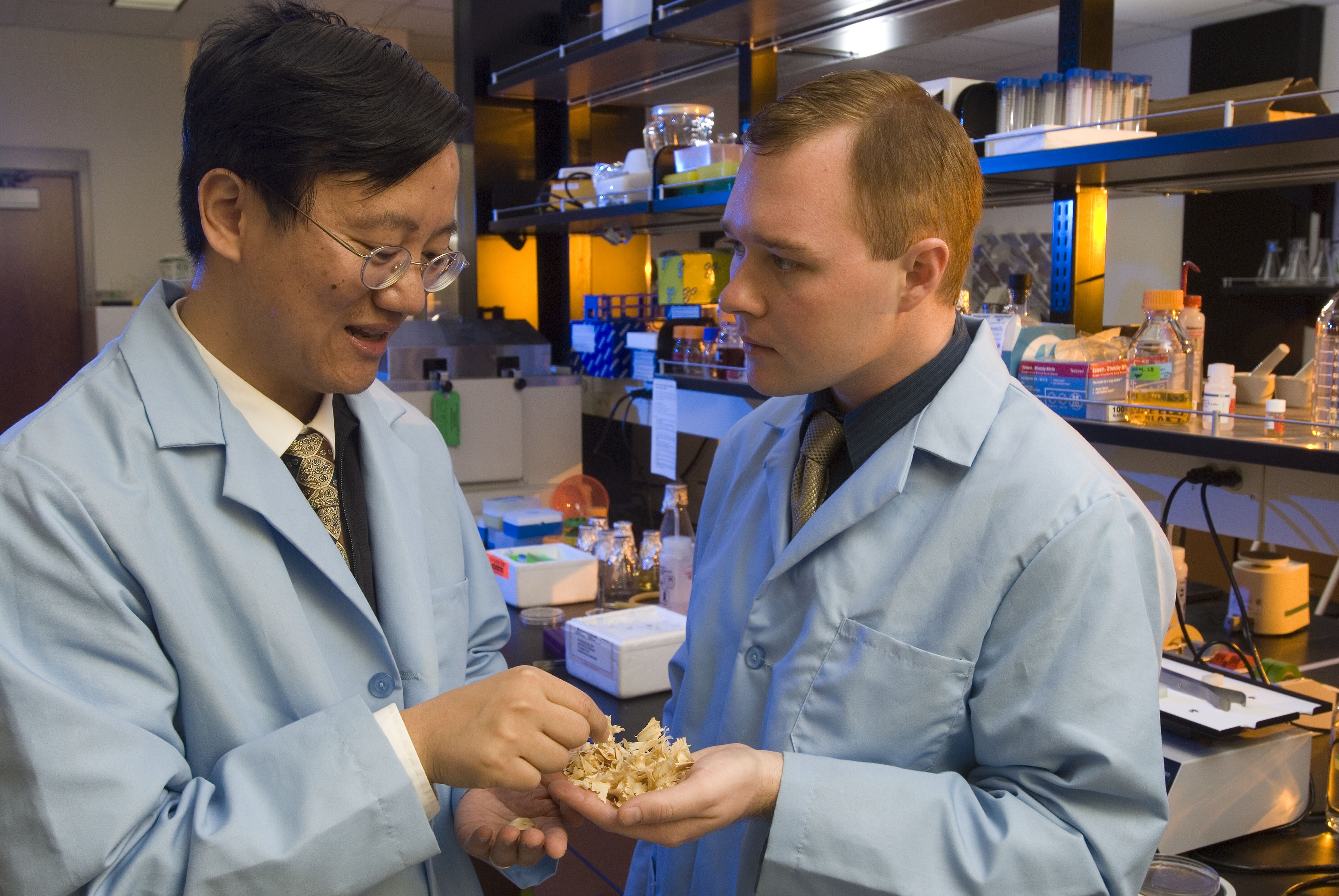 Percival Zhang (left) discusses conversion of biomass to energy with Geoff Moxley, who recently received his master of science degree in biological systems engineering from Virginia Tech.