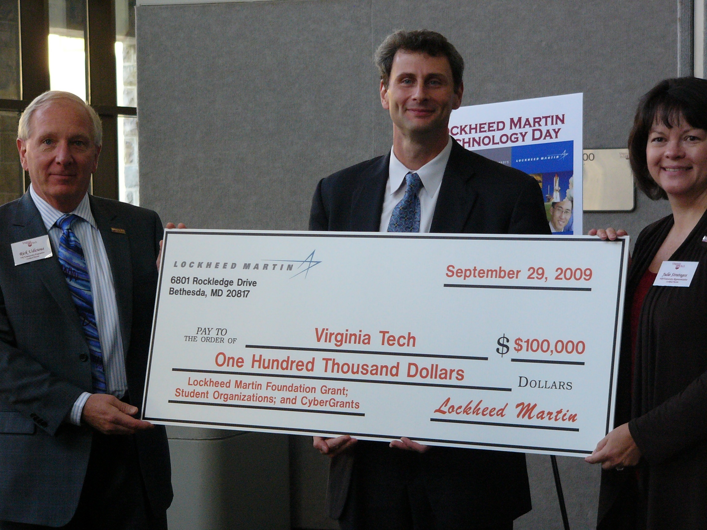Rick Udicious (left) vice president and general manager of Lockheed Martin MS2 Tactical Systems and Julie Strategos (right) Tech Ops vice president of Lockheed Martin MS2 Underseas Systems, present the oversized check representing the $100,000 gift to Don Leo, associate dean for research and graduate studies of Virginia Tech's College of Engineering.