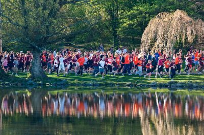 A large group of runners run past the Duckpond
