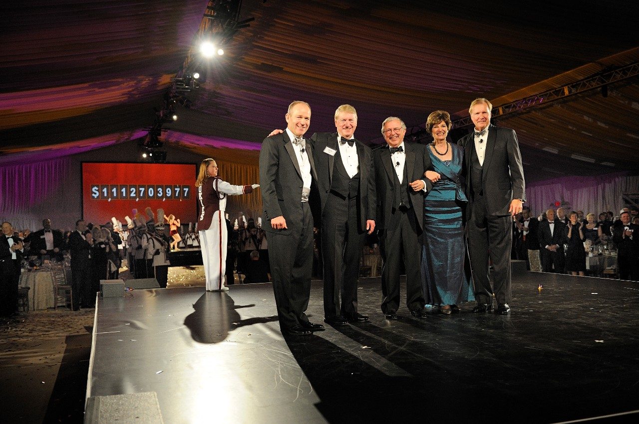 (From left) David Calhoun, Gene Fife, Virginia Tech President Charles W. Steger, Elizabeth Flanagan, and John Lawson appear before the screen that revealed the total amount raised during The Campaign for Virginia Tech: Invent the Future. 