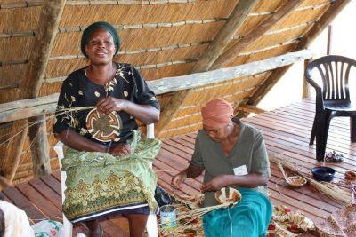 Two women making baskets at the craft center.
