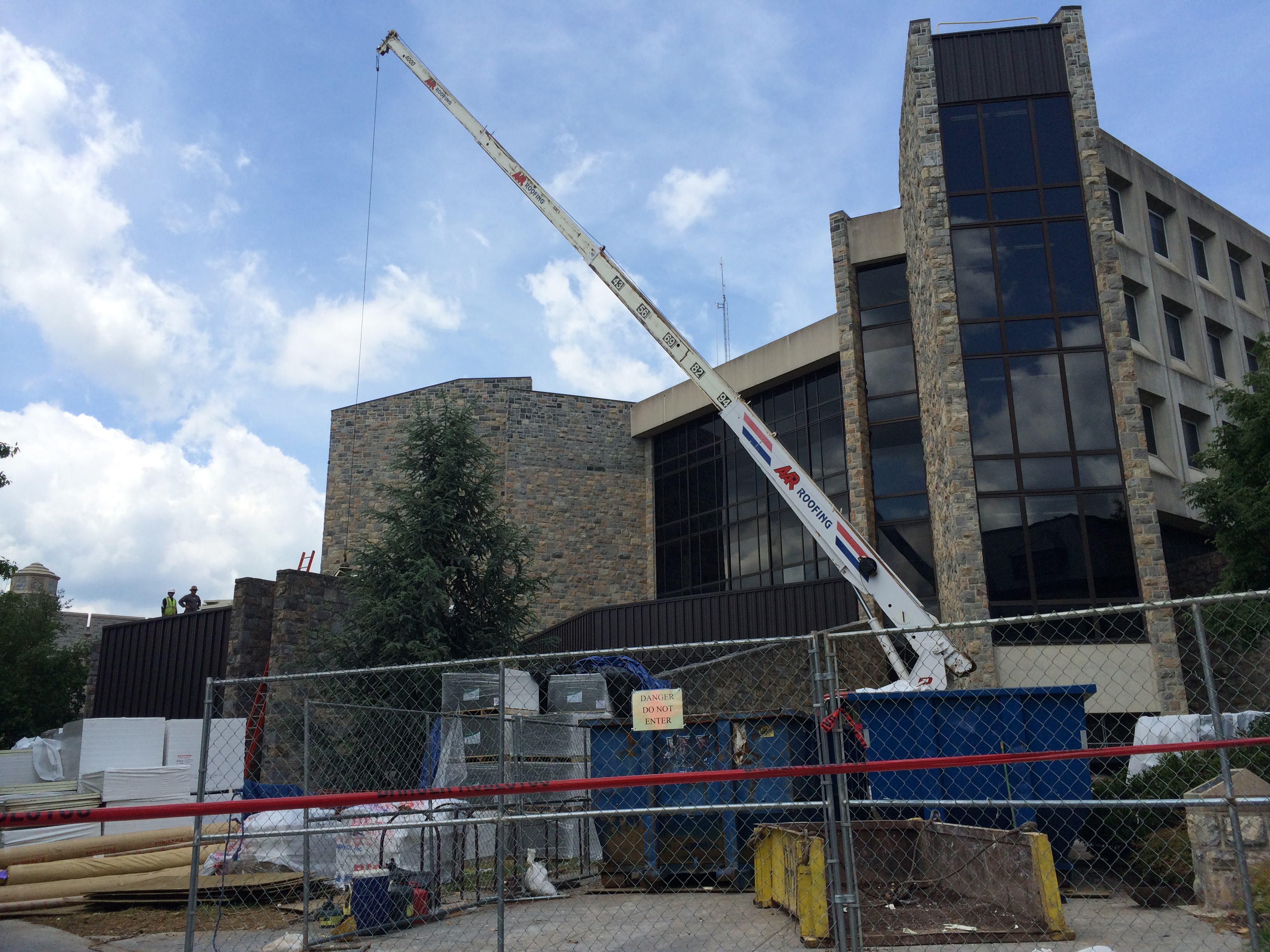 Crane hauling materials for McBryde Hall roof project
