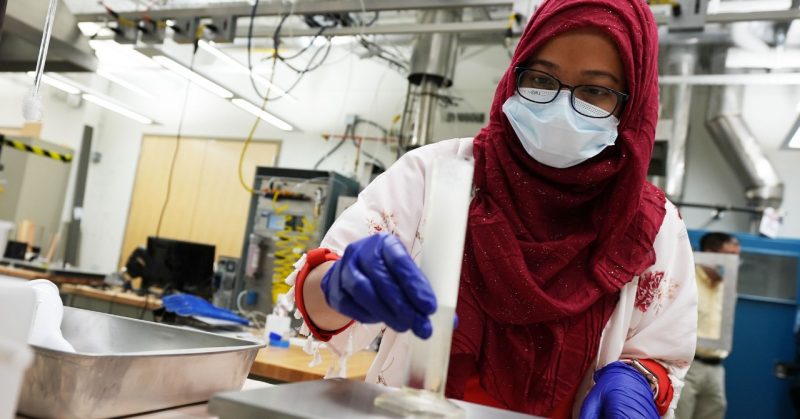 Rezawanna Islam works with a foam sample in the EXTREME lab.
