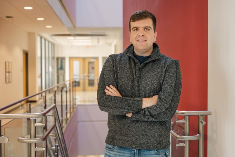 Zach Kozar, biomedical engineering and mechanics graduate, stands in Kelly Hall on Virginia Tech campus