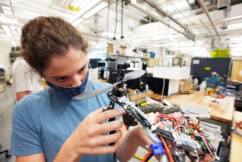 Heather Wotton works with a 3D-printed drone in the DREAMS Lab.