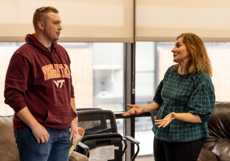 Jana Moser-Moore, director of the Office of Veteran Services, speaks with a student at the grand reopening of the VeTZone space in the Johnston Student Center.