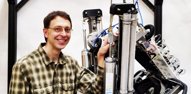 Alan Asbeck with an exoskeleton built by his lab.