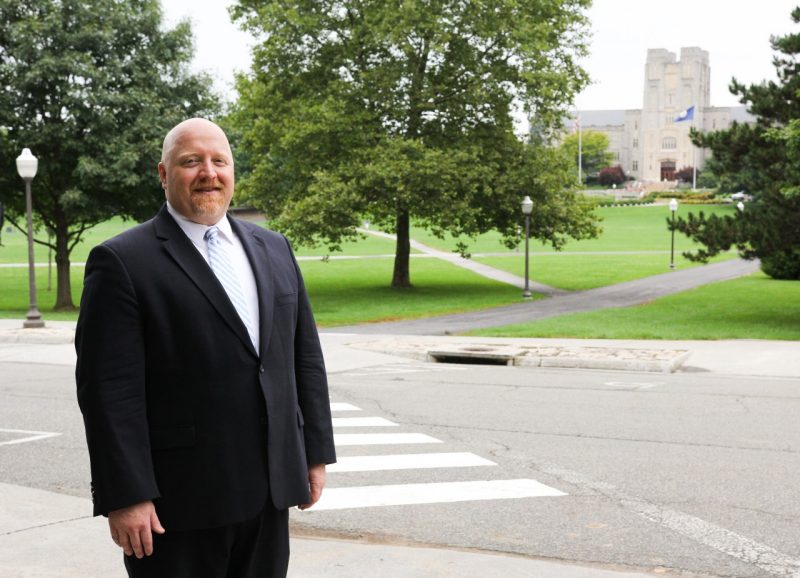 Dale Pike, the associate vice provost of TLOS, poses across the Drillfield from Burruss Hall.