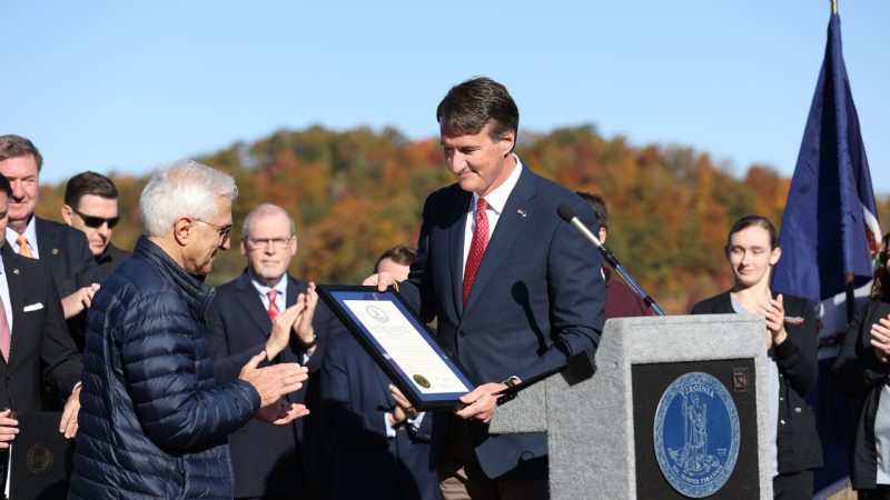 Alireza Haghighat (at center) is presented with a certificate by Governor Glenn Youngkin (at right) at the Energy Innovation investment announcement in Norton, Virginia on October 14th, 2022.