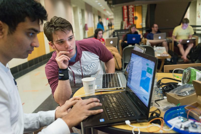 Participants at a hackathon on campus last year work on their project.