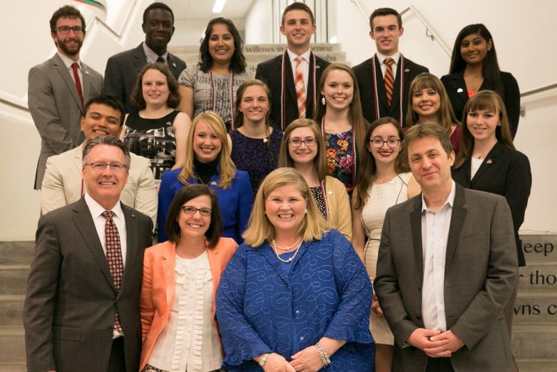President Tim Sands, Laura Sands, Vice President for Student Affairs Patty Perillo, and Executive Vice President and Provost Thanassis Rikakis pose with the inaugural cohort of 15 Keystone Fellows at the Moss Arts Center.