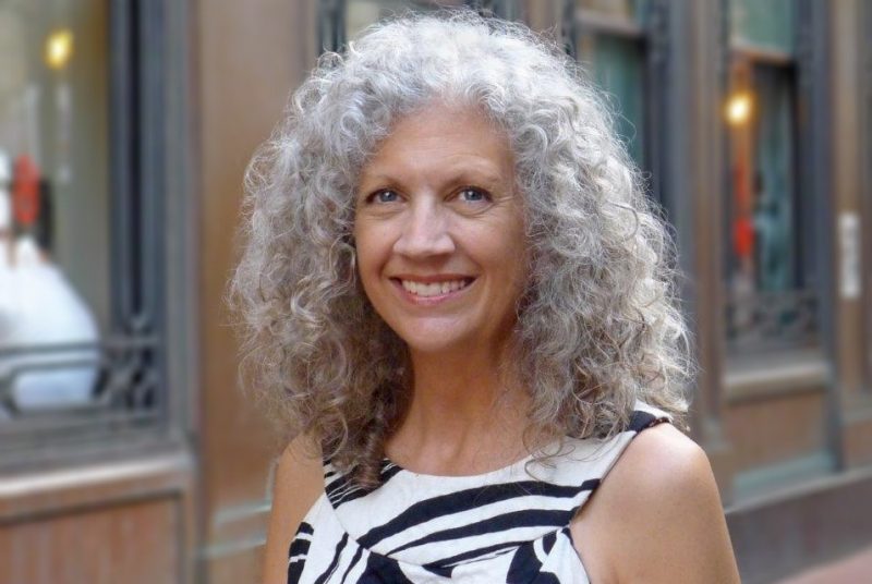 A photo of Susan Piedmont-Palladino standing outdoors on a city sidewalk.