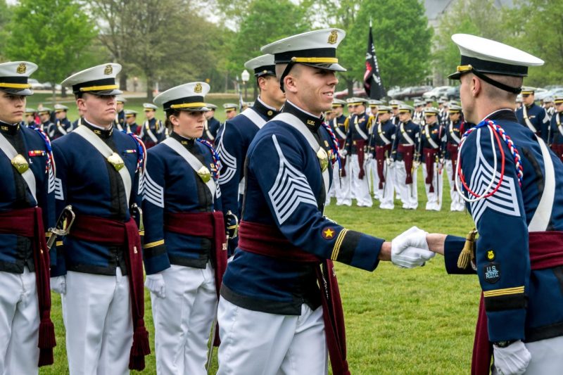 Mike Schoka, at center, shakes the hand of the outgoing regimental commander, at right, during a change of command ceremony.