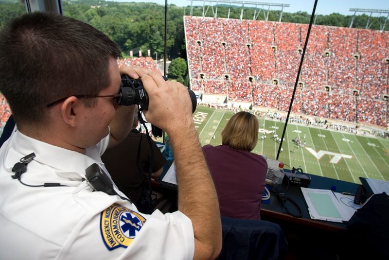 A rescue squad members monitors a home football game
