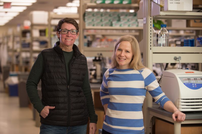 Deb Kelly, Ph.D., and Cameron Varano stand in the Kelly Laboratory. 