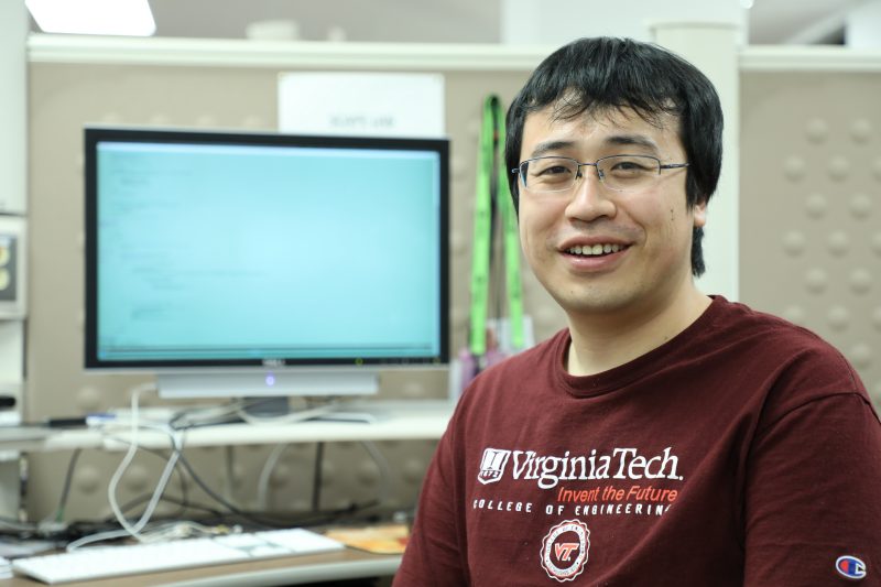  A young man of Asian descent in front of a computer.