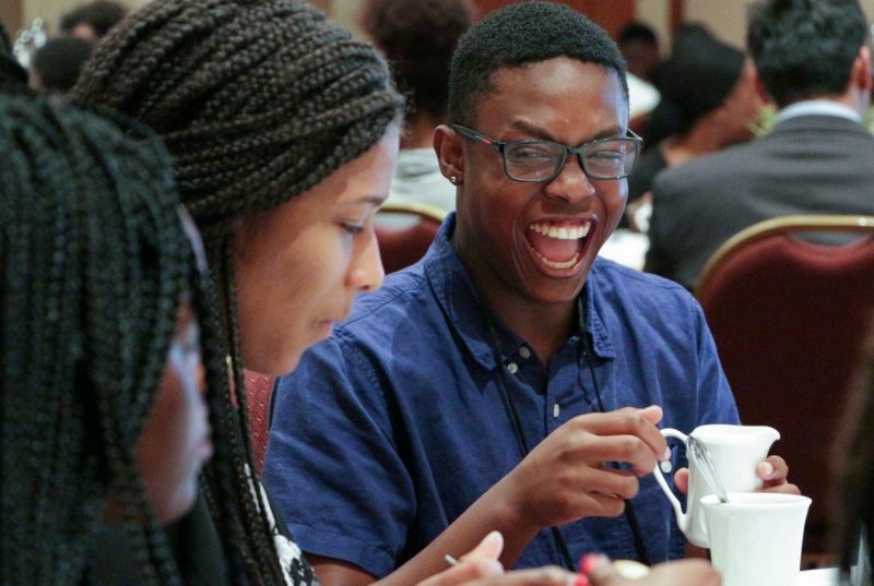 Provoked by friends, Eric Jones bursts into laughter during an etiquette lunch in the Latham Ballroom at The Inn at Virginia Tech. 