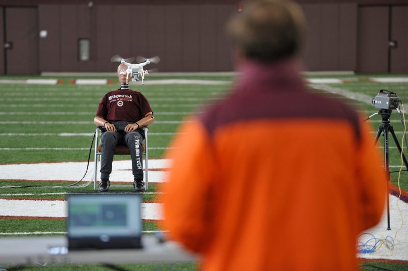 Researcher piloting drone into a dummy 