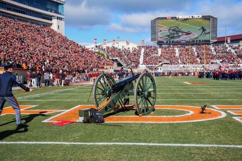 Members of the Virginia Tech Corps of Cadets' Skipper Crew fire the cannon inside Lane Stadium.