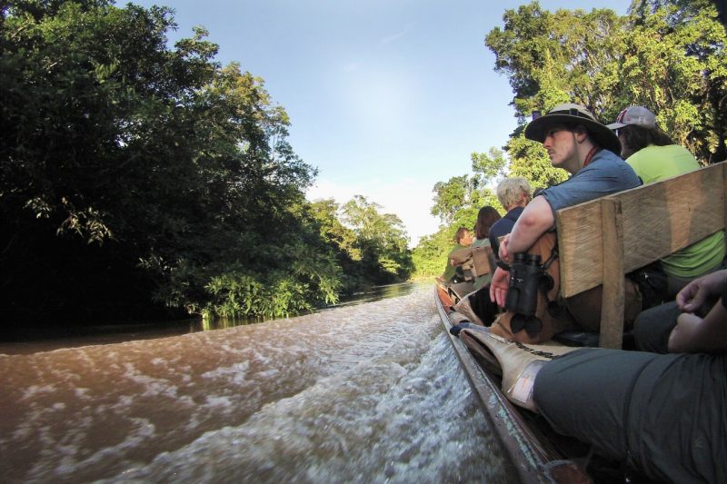 Students traveling by boat down a river in Ecuador.