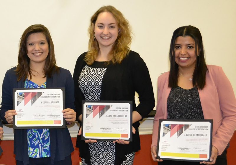 A photograph of Megan A. Lorincz, Joanna Papadopoulos, and Fadoua El Moustaid, three graduate students holding certificates recognizing their work as Citizen Scholars by the Graduate School