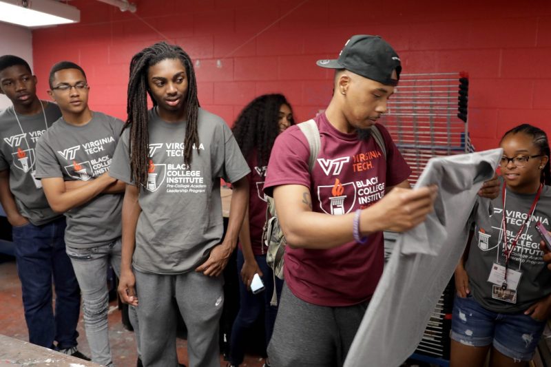 Students look at another student's t-shirt