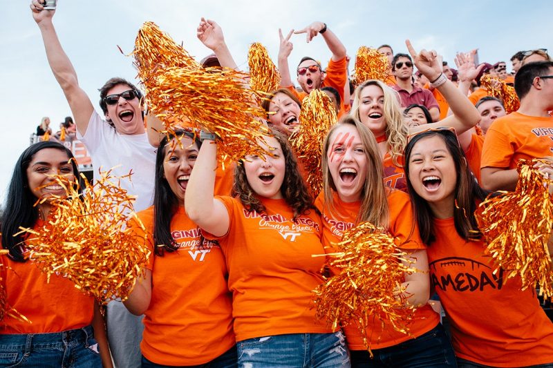 Students cheer at a recent Hokie football game. 