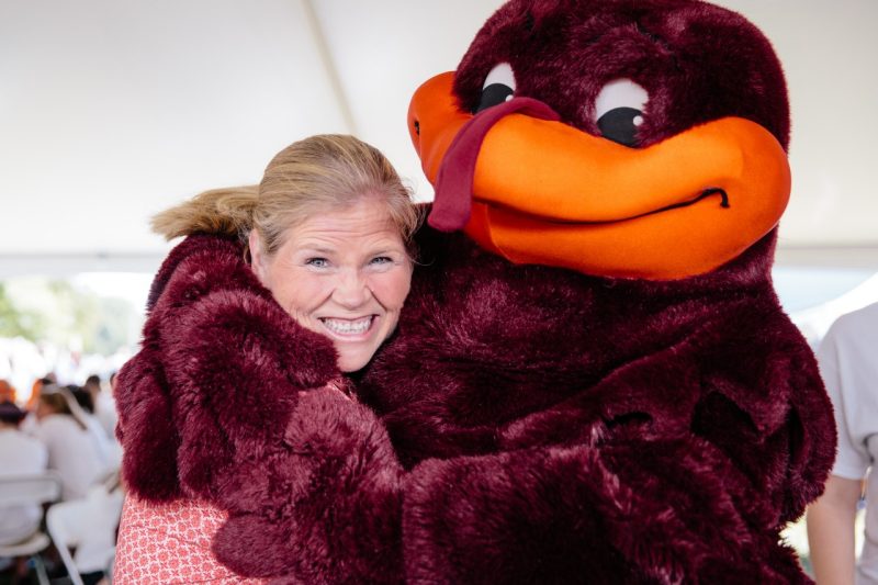 Dr. Perillo and the HokieBird Dr. Patty Perillo gets a hug from the HokieBird