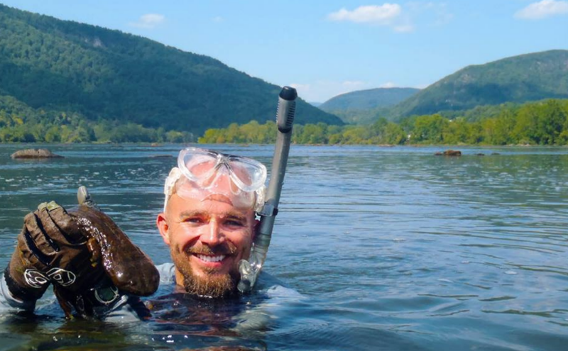 Researcher with a hellbender salamander