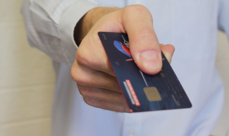 Image of man holding credit card 
