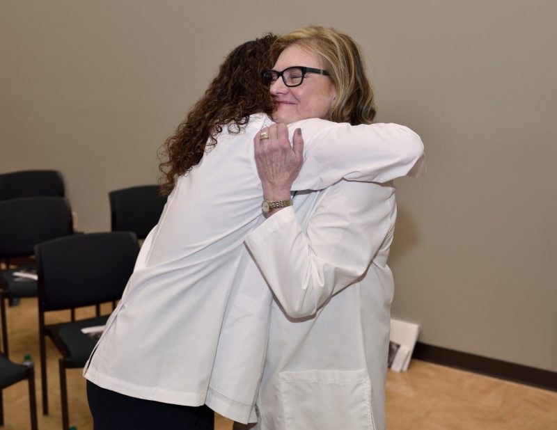 Michaela Pesce gives Founding Dean Cynda Johnson a hug