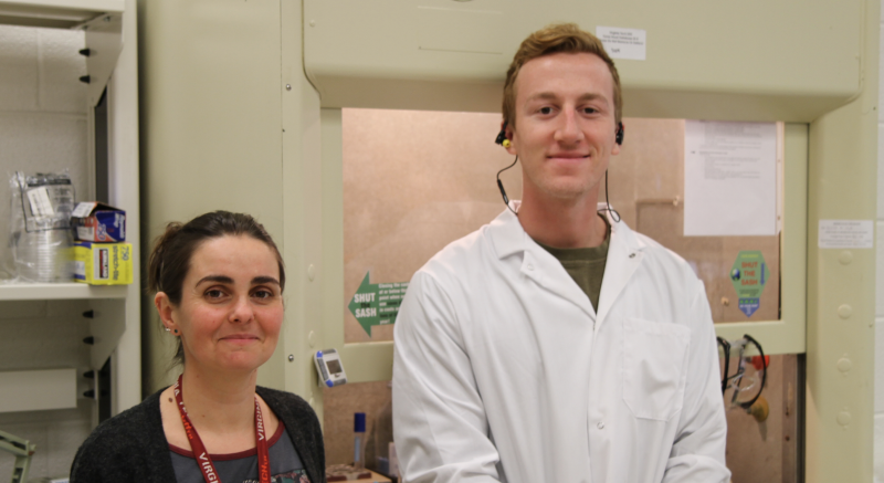 Researchers in front of a fume hood. 