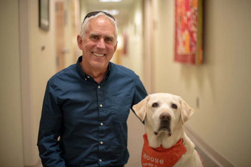 Trent Davis, counselor and coordinator of Virginia Tech’s Animal Assisted Therapy at Cook Counseling Center, and his dog Moose, a 7-year-old therapy dog.