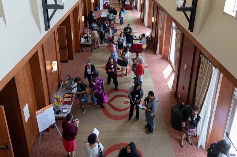 Attendees of the seventh annual Faculty Women of Color in the Academy conference walk through the exhibition area.