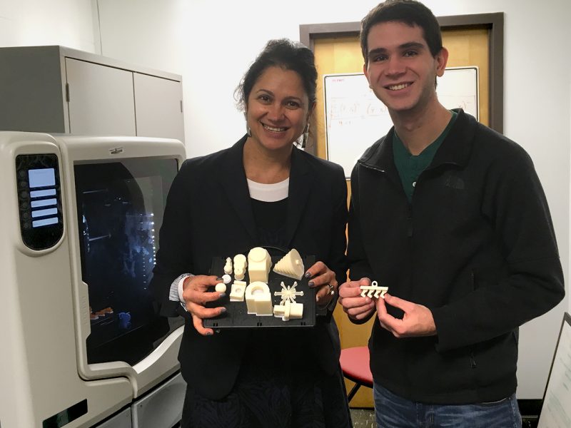 Assistant Professor Diana Bairaktarova and Graduate Assistant Sam Snyder holding 3D-printed ornaments just removed from a 3D printer in the Abilities, Creativity, and Ethics in Design—ACE(D) Lab