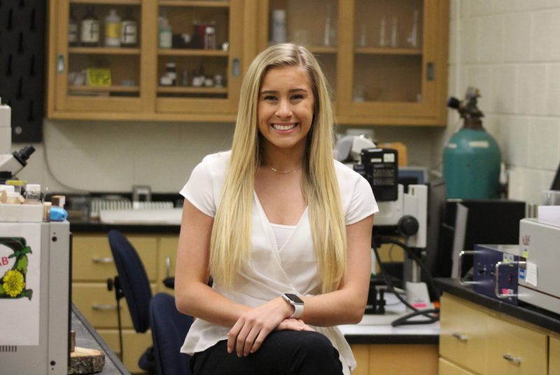 Erin Lash sitting in a laboratory