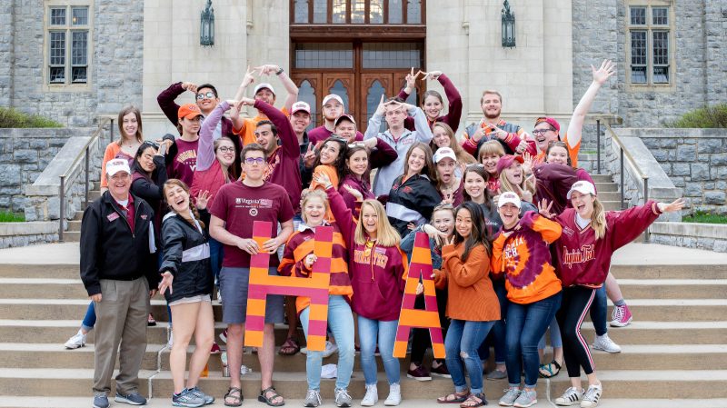 The Hokie Ambassadors get pumped up to give their signature campus tours during Hokie Focus weekend.