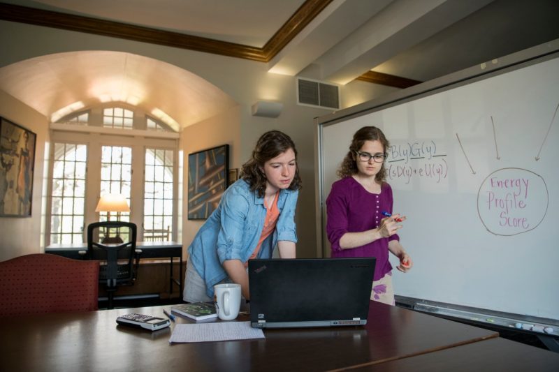 Aimee Maurais and Arianna Krinos work on a math competition problem  