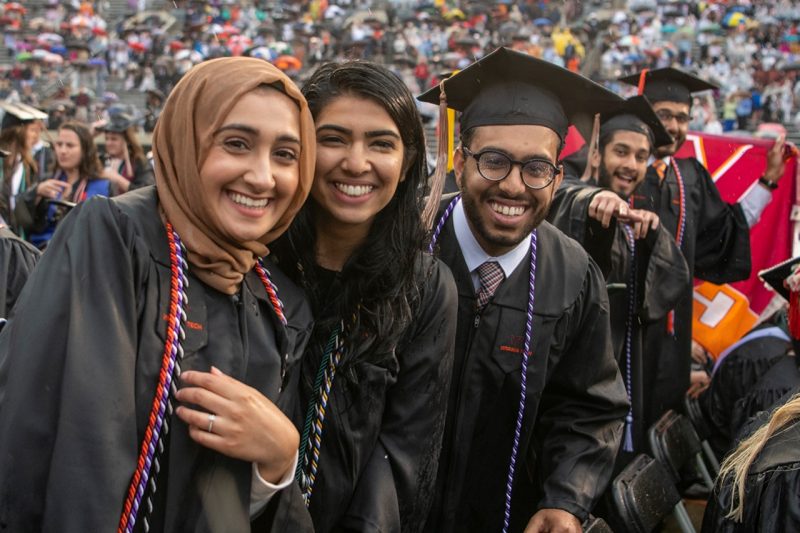 Graduates manage to smile despite the rain