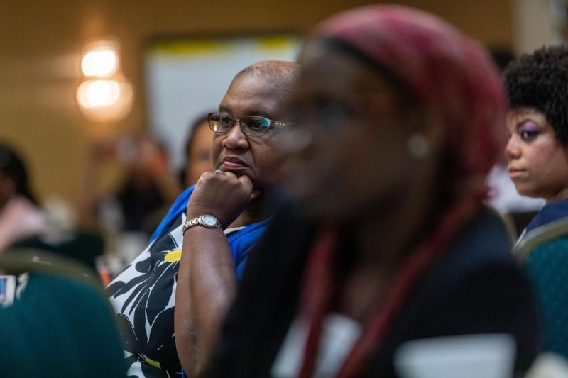 An alumna listens to a presentation at the Black Alumni Summit.